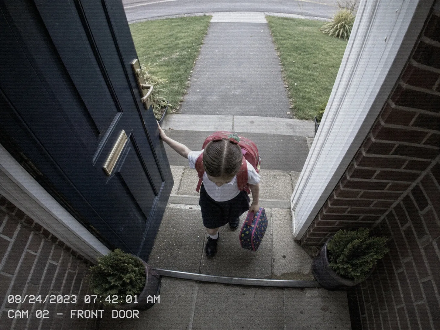 Noor leaving through the front door for school.