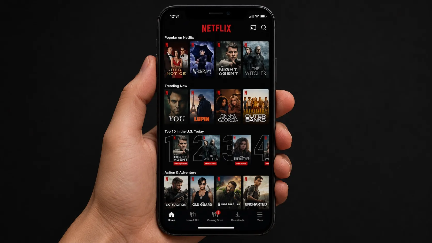 A hand holding a smartphone displaying the Netflix app with vertical rows of trending titles including The Witcher, Wednesday, Lupin, and Outer Banks